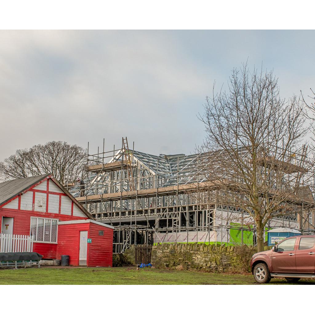 A glimpse of the past and a view of the future as Lightcliffe's long-awaited new clubhouse takes shape and rises above the historic 100-year-old  wooden pavilion
